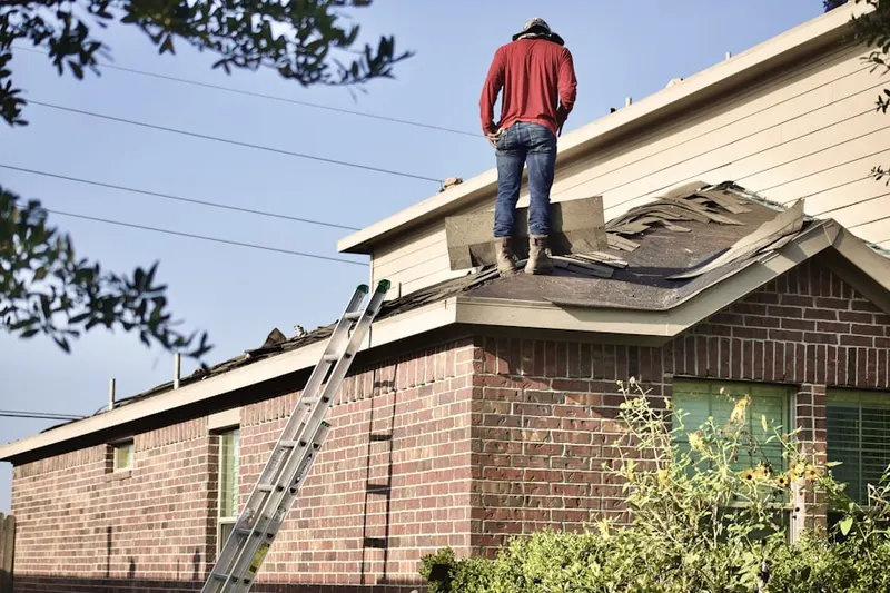 Professional roofer working on a residential roof in Colusa